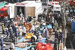 Large-scale rescue operations with an expandable special ambulance deployed.