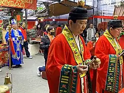 Taoist priests of Taiwan wearing ceremonial garments consisting of fayi and cross-collared inner robes, Tucheng District, New Taipei City.