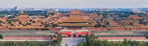 Bird's-eye view of the Forbidden City: beyond the walls, rows of red rooftops stretch into the distance, fading into the mist