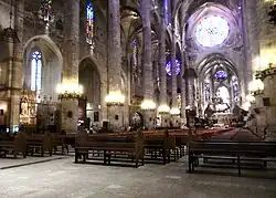 Palma Cathedral on Mallorca in Spain has windows on three levels, one above the aisles, one above the file of chapels and one in the chapels.