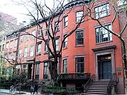 Photo of a 3-story red brick building, taken from street outside