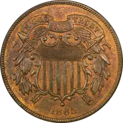 A bronze coin with a shield in the center, dated 1865.