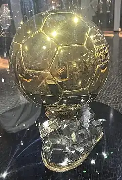 The Ballon d'Or trophy, a golden football mounted on a base