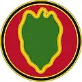 A red circle with a black outline containing a green leaf shape with a yellow outline