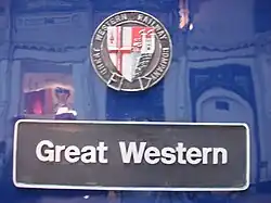A black nameplate stating "Great Western" with a multi-coloured shield above.