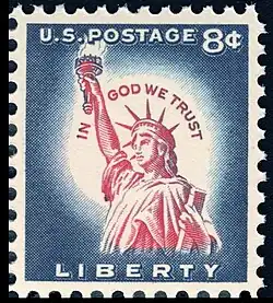 8¢ postage stamp from 1954, with the motto inscribed around the Statue of Liberty's head, in the white area surrounding her head. At the time, eight cents was the standard rate for international postage. A 3¢ (domestic mail rate) stamp with a similar design was also issued.