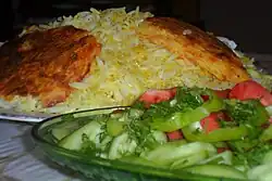 Azerbaijani plov with caramelized rice, served with choban salad
