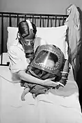 Mother and baby with gas masks, 1941