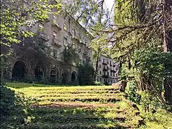 Abandoned concrete apartment buildings in a forested valley