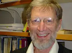 Head shot of Plantinga wearing glasses and smiling