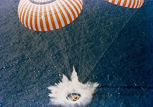 Photo of the splash from above. Two of its circular parachutes are visible in the image.