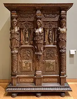 Henry II style wardrobe; c. 1580; walnut and oak, partially gilded and painted; height: 2.06 m, width: 1.50 m, depth: 0.60 m[128]