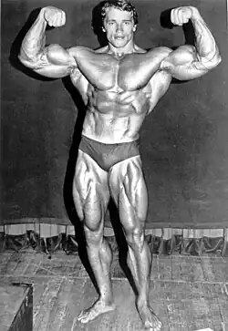 Schwarzenegger in a speedo flexing his muscles