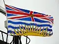 Flag of British Columbia showing a Union Flag, defaced with a gold crown, in the upper division