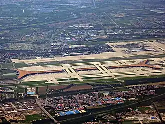 Aerial view of Terminal Three of Beijing Capital International Airport (orange roof in center) by Norman Foster (2008)