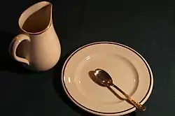 A British Transport Hotels table set, consisting of a items likely a gravy boat, saucer, and teaspoon.
