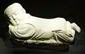 White-glazed pillow in the shape of an infant boy; ding ware, Northern Song Dynasty (960–1127)