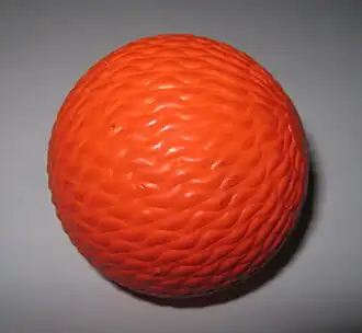 Bandy balls are vividly coloured to aid visibility against the ice