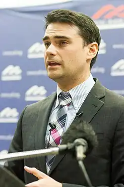 a man with dark hair wearing a color-matching yarmulke