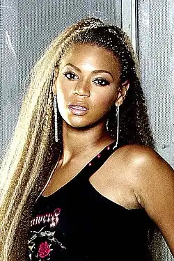 Beyoncé in a black top, photographed looking directly at the camera