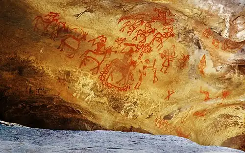 People riding horses holding weapons