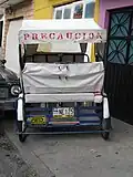 A "bicitaxi" (identified by its license plate) in Ciudad Nezahualcoyotl, Mexico