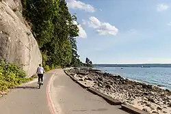 A person riding a bike along Vancouver's Stanley Park Seawall.