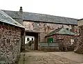 Old stone building with archway.