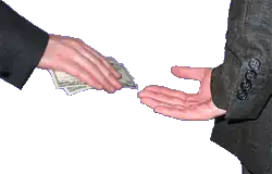 One hand giving money to another hand, held behind a back.