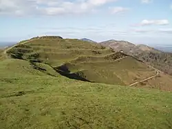 Photo of the British Camp hill showing its terraced Iron Age earthworks