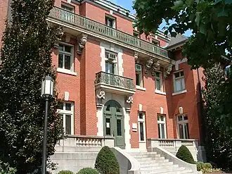 Ornate upper bronze balustrade, lower vasiform stone balustrade, and bronze central rail supported by decorative bronze metalwork at Brown University's Orwig Music Library, Providence, Rhode Island