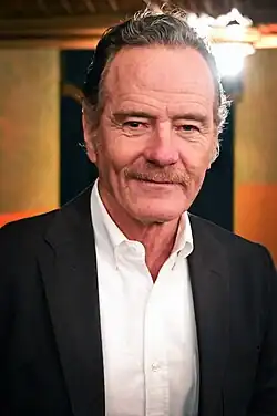 Head shot of Cranston wearing glasses