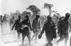 Many prisoners of war, walking on a dusty road