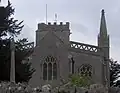 Stone building with arched windows and a square tower.