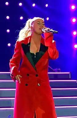Aguilera singing into a microphone