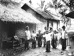 Young dancer accompanied by angklung players in Baduy, Banten. c. 1910-1930.