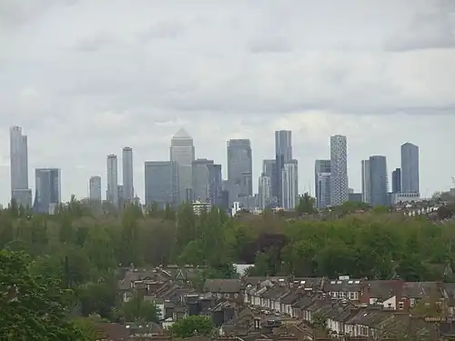 The Canary Wharf and Isle of Dogs business district as viewed from Blythe Hill Fields, London Borough of Lewisham, May 2021. The tallest building in this cluster is One Canada Square with the pyramid-shaped roof which was completed in 1991 and stands at 235&nbsp;m. There are seven towers in this cluster that are at least 200&nbsp;m tall with more planned and under construction. However, due to the proximity of London City Airport it is unlikely that any will exceed the height of One Canada Square