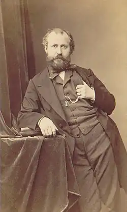 photograph of man in early middle age, balding, with neat moustache and beard