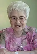 Head shot of Lubich smiling and wearing glasses