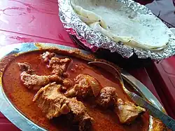 A chicken curry from Maharashtra, India with rice flour chapatis. The dish is popular worldwide.[41]