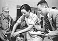 Soong giving a bandage to an injured Chinese soldier (c. 1942)[55]