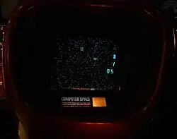 Photograph of gameplay, with white dots on a black screen and instructions below