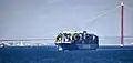 A container ship moving south past 1915 Çanakkale Bridge in 2024