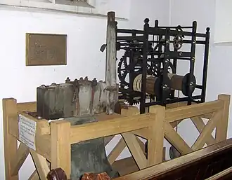 Wooden framework containing metal mechanical mechanism.