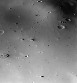The surface of Deimos, a moon of Mars, is covered by a layer of regolith estimated to be 50 m (160 ft) thick. Viking 2 orbiter image is from a height of 30 km (19 mi).