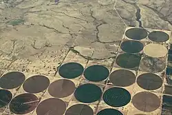 Farmland in the United States. The round fields are due to the use of center pivot irrigation