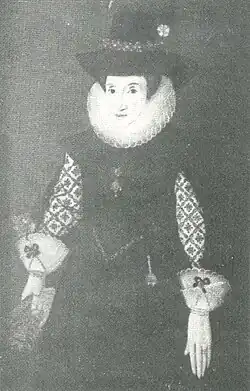Formal portrait of Dorothy Davenport. She wears a dress of plain dark cloth with richly embroidered undersleeves, a ruff and frilled cuffs. On her head is a high-crowned felt hat trimmed with a flower.