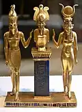 Osiris on a lapis lazuli pillar in the middle, flanked by Horus on the left, and Isis on the right, between 874 and 850 BCE, Louvre