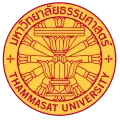 The seal of Thammasat University in Thailand consisting of a Constitution on phan with a twelve-spoked dhammacakka