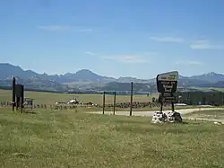 Mountains and grasslands surrounding a work center.